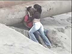 Latino couple caught on the beach